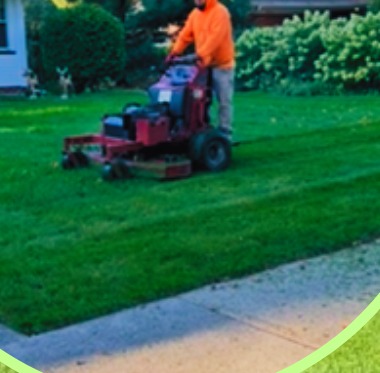 T&D Landscaping crew mowing a lawn