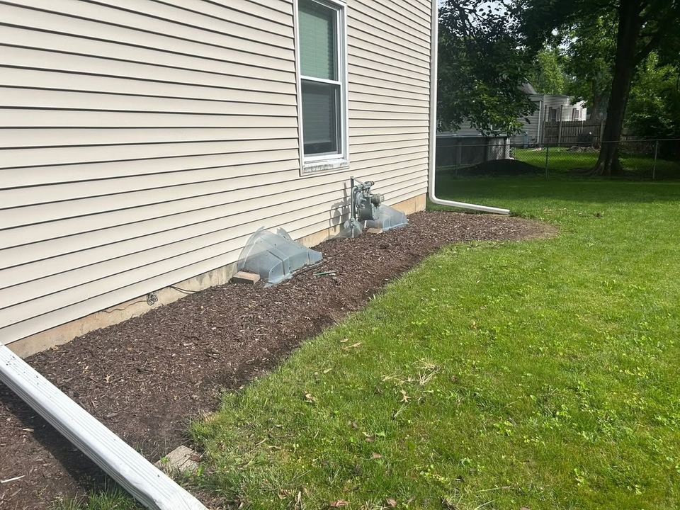 Fresh mulch bed along a home